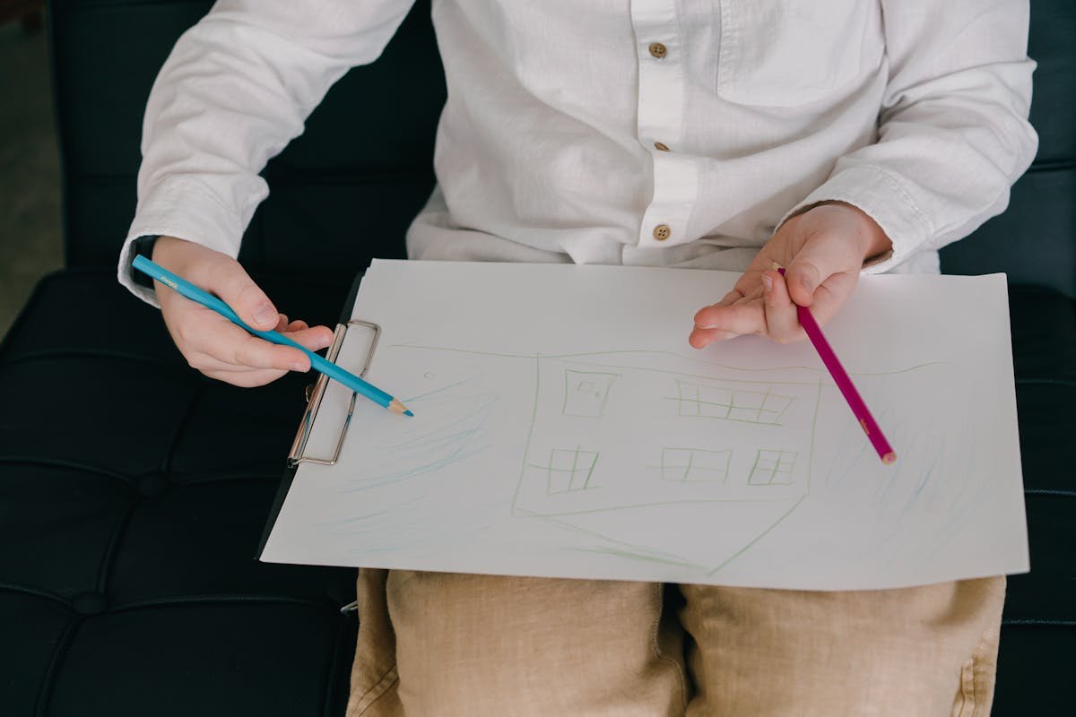 Close-up of a young child's drawing in progress, work being captured